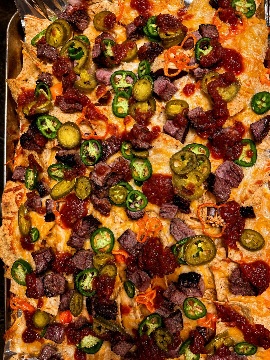 Bobchos — loaded nachos piled with smoked beef, jalapenos, cheese, and salsa